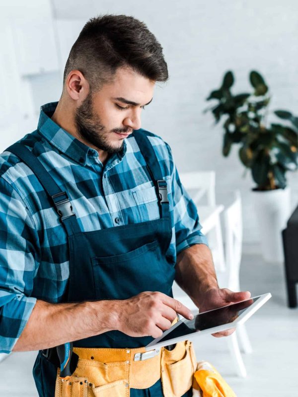 bearded-handyman-pointing-with-finger-at-digital-tablet.jpg